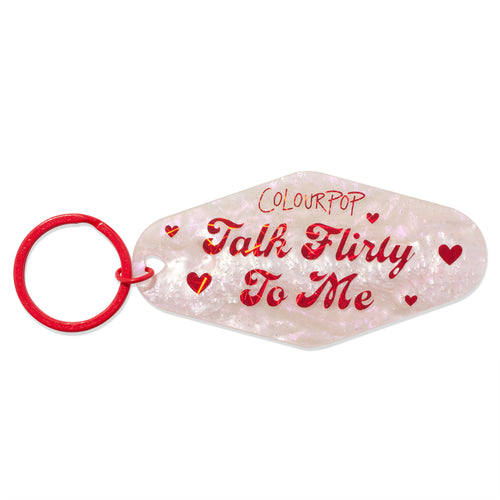 Pearlescent pink motel-style keychain reading “Talk Flirty To Me” with red hearts, a red split ring, and ColourPop logo, the Flirty Talk accessory from ColourPop Tools and Accessories.