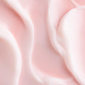 Good Mood Gel Moisturizer spread in glossy, pale pink swirls, showcasing the lightweight gel-cream texture of this ColourPop Face Moisturizer in a close-up on a smooth surface.