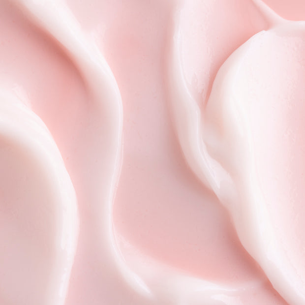 Good Mood Gel Moisturizer spread in glossy, pale pink swirls, showcasing the lightweight gel-cream texture of this ColourPop Face Moisturizer in a close-up on a smooth surface.
