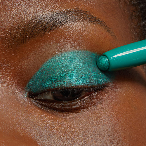 ColourPop Surf Sesh Shadow Stix glides a vibrant metallic teal eyeshadow across a closed eyelid, showcasing creamy, high-pigment payoff and smooth blend in a close-up application.