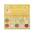 Sweet As Can Bee ColourPop Shadow Palette opens to reveal 10 hex-shaped eyeshadows - warm honey-inspired mattes and shimmers in gold, amber, pink, and green - arranged in a honeycomb inside sage-and-mustard packaging with Winnie the Pooh floral artwork.